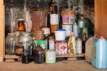 Bunch of old rusty paint cans in a rack - In the workshop