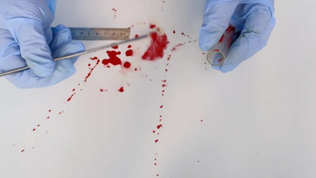 evidence idfresh splatter of red blood on white table, sharp knife stained at crime scene, forensic expert examines surfaces, collects evidence, forensic medical examiner work concept