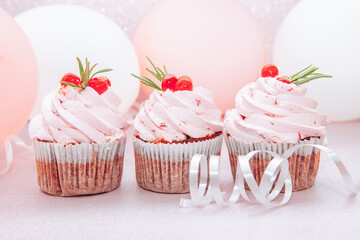 Colorful three pink cupcakes with air balloons, beautiful card with sweet food and celebration concept