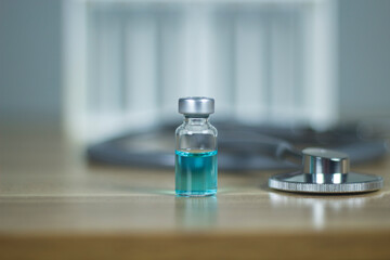 One bottle of vaccine on the table subcutaneous vaccination Vaccination. Stethoscope health medical concepts, treatment concepts