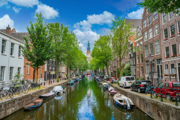 Amsterdam, The Netherlands 23th June 2021 -Deserted Groenburgwal Canal with view on the Zuiderkerk...