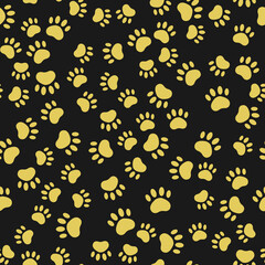 Seamless pattern with gold cat paws on black background