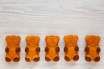 Homemade Sweet Bears Cookies on a white wooden table, top view. From above, flat lay, overhead. Copy space.