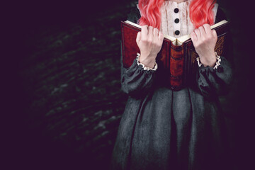 Witch as a student on a dark background for Halloween