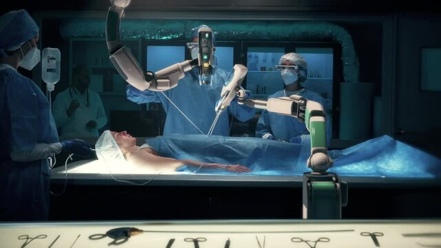 Team of surgeons wearing special augmented reality glasses perform a delicate operation using medical surgical robot arms. Modern medical equipment. Robotic arm for minimal invasive surgery.