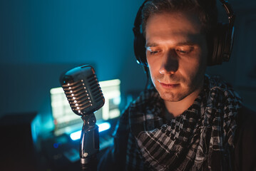 Handsome man recording a song in record studio.