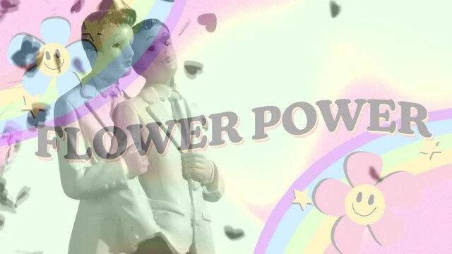 Animation of flower power text with rainbow and flowers over figurines of newly wed two gay grooms