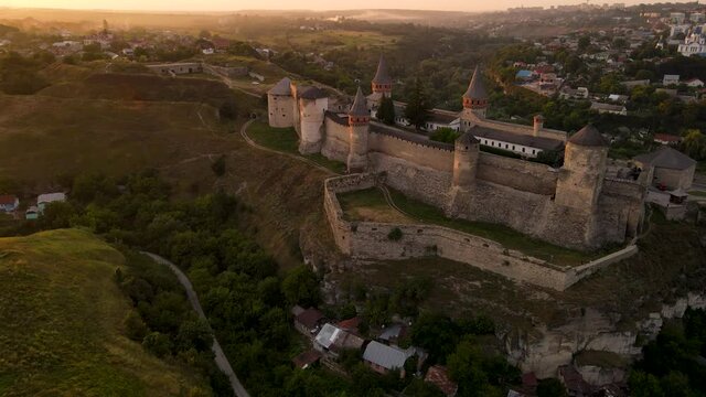 Aerial drone view of medieval castle at sunset in Kamianets-Podilskyi town