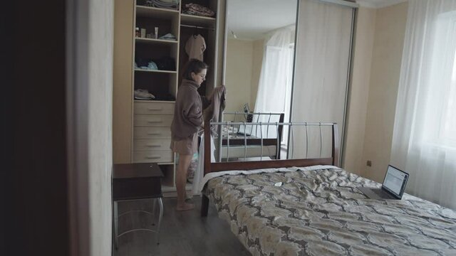 Woman changing clothes at home