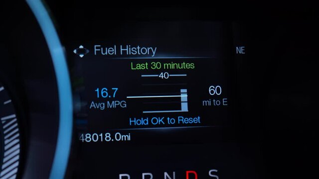 Car display with Fuel range, oil life, tire pressure, speed, fuel economy. 4K video footage.