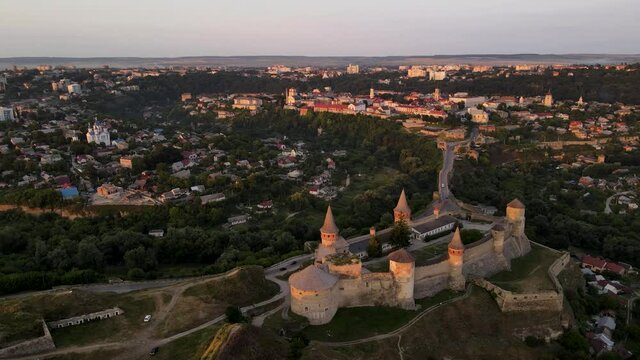 Aerial drone view of medieval castle at sunset in Kamianets-Podilskyi town