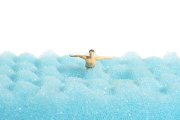 Miniature people toy figure photography. Swimming water sport. A young men butterfly style swimmer...
