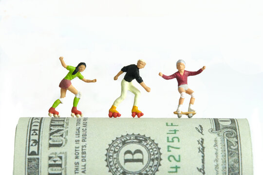 Miniature people toy figure photography. Skateboard winning prize concept. A young skateboarder girl above dollar money paper, isolated on white background. Image photo