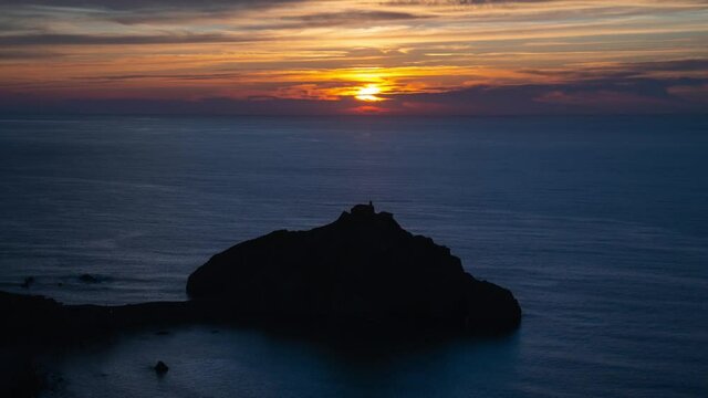 Timelapse sunset of San Juan de Gaztelugatxe in Basque Country, Spain. Very famous and touristic Spanish island surrounded by the sea. 4k video. Spain tourism in summer. Travel destination.