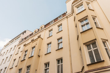 yellow facaded apartment house from the low angle view