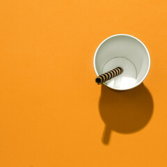 Chocolate waffle tube and plastic cup. Sweets sugar lover concept. Minimal art. Holidays party time, winter christmas celebration