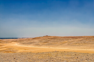 Desert landscape looking across a valley from one sand dune to another.