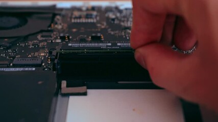 Hands holding computer RAM memory plate. Computer diagnostics concept. Laptop repair. 4K video footage.