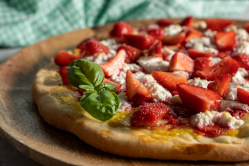 Strawberry and banana pizza with ricotta cheese and mango sauce.