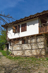 Fototapeta na wymiar Street and old houses at historical village of Bozhentsi, Bulgaria