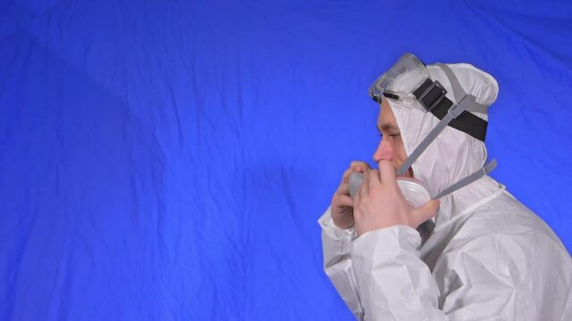 Scientist virologist in respirator. Slow motion. Man close up look, wearing protective medical mask. Concept health safety N1H1 virus protection coronavirus epidemic 2019 nCoV. Chroma key blue film.