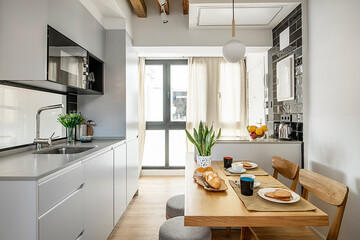 Kitchen in small vacation rental apartment with breakfast served at the office table with coffee,...
