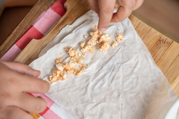 Housewife making putting cheese in yufka, make traditional Turkish sigara boregi (cigarette borek).