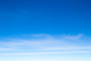 Clear blue sky with white cloud background