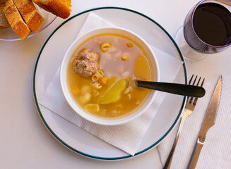 Delicious nutritious soup with pasta, meatballs, potato slices and chickpeas. Typical dish of Catalonia and Murcia