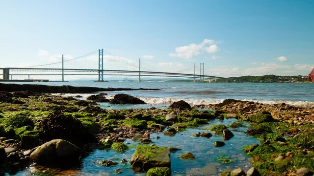 Stunning view of the Firth of Forth in Scotland, UK, featuring the Forth Railway Bridge, an amazing feat of Victorian engineering. The Forth Bridge was inscribed as a UNESCO World Heritage Site