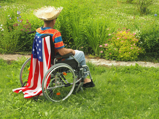 Handicapped with USA flag on park landscape background . Outdoor