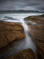 water flowing into a body of water