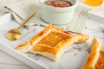 Tray with danish pastry on white wooden background