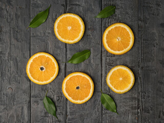 Five pieces of orange and green leaves on a wooden background. Flat lay.