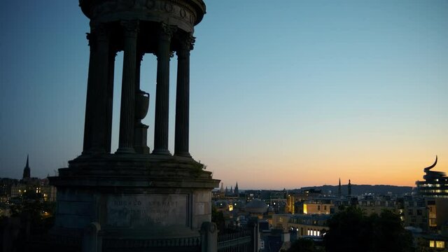 Twilight panorama of Edinburgh, Scotland, UK, featuring the Dugald Stewart Monument in Calton Hill, the Old Town and New Town. The city of Edinburgh is a UNESCO World Heritage Site