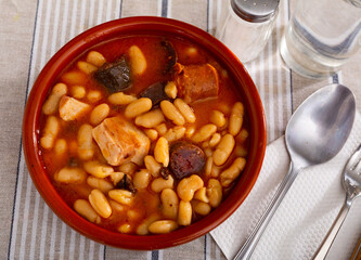 Traditional delicious dish of Spanish cuisine is Fabada soup, made from white Asturian beans with...