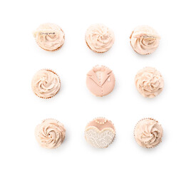 Tasty wedding cupcakes on white background