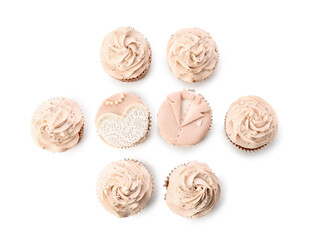 Tasty wedding cupcakes on white background
