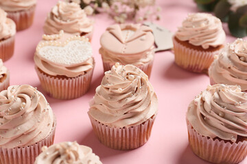 Tasty wedding cupcakes on color background