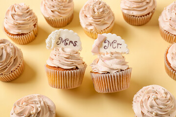 Tasty wedding cupcakes on color background