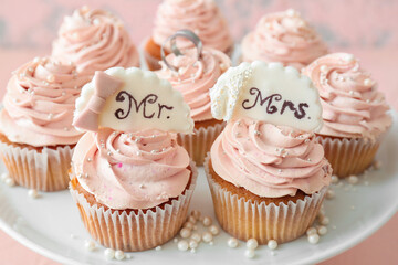 Dessert stand with tasty wedding cupcakes, closeup