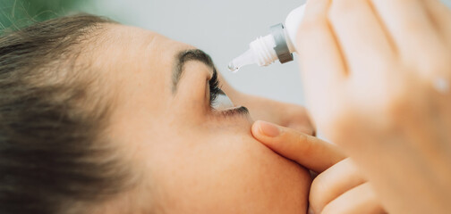 Young girl buries her eyes with special eye drops