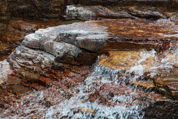 Water flowing over brown rocks