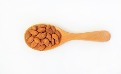 Almonds nuts in wooden spoon isolated on a white background. View from Above