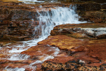 Water flowing over brown rocks