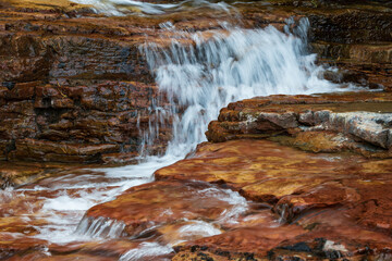 Water flowing over brown rocks