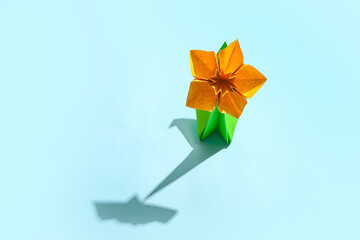 Origami narcissus on color background