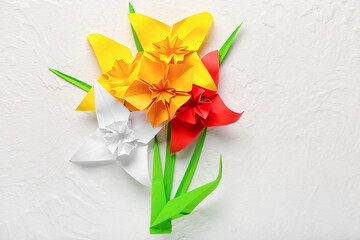 Origami daffodils on light background