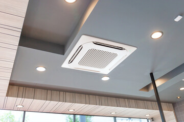 Modern ceiling mounted cassette type air conditioning system in coffee shop