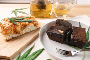 Food and drink and cannabis leaves on the dining table. Alternative medicine concept.